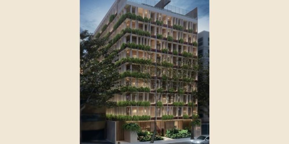 Guilhem Mozak Leblon - Perspectiva da área comum do rooftop à noite, com iluminação suave e vista privilegiada da cidade, destacando o lazer sofisticado do empreendimento.