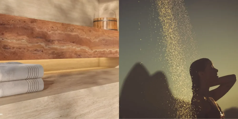 Sauna do Sal Praia de Ipanema com acabamento em mármore e toalhas dobradas ao lado de mulher tomando ducha ao pôr do sol com o Dois Irmãos ao fundo
